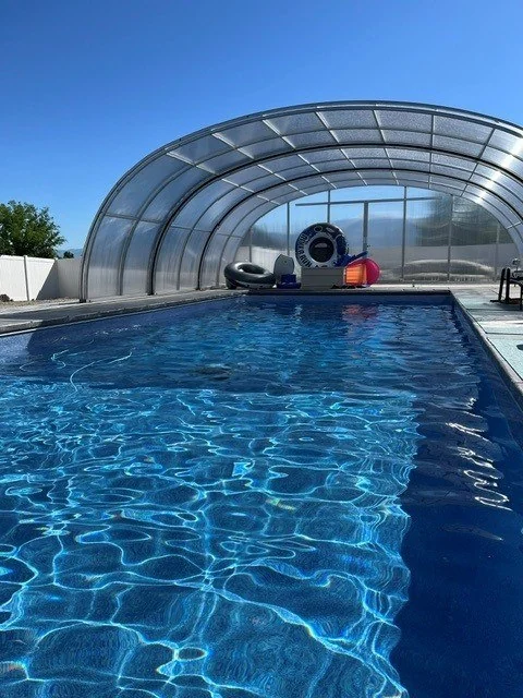 Silverpoint Aquatics pool beneath its arched enclosure on a clear day