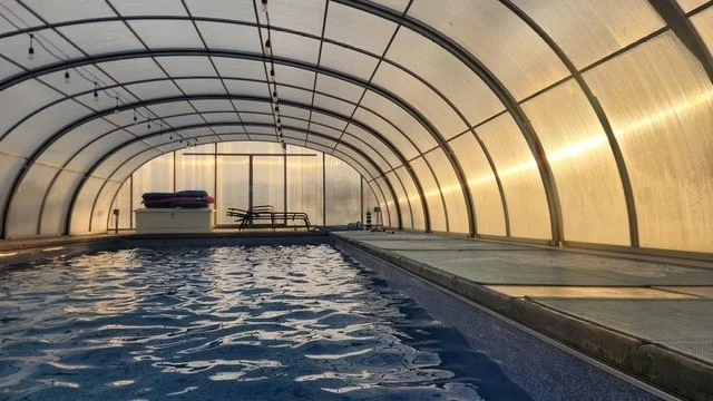 Wide view across the Silverpoint Aquatics pool inside its arched enclosure