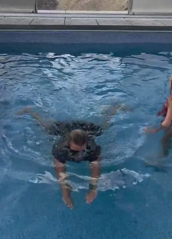 A Silverpoint Aquatics instructor guiding a young swimmer during a private lesson